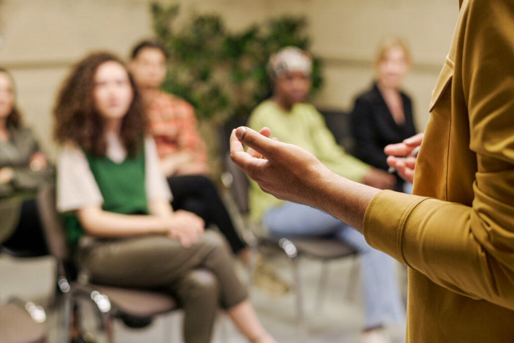 A woman is giving a presentation to a group of people