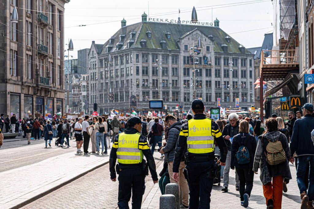 Photo of police officers walking through a busy downtown area